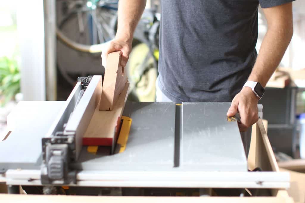 A man uses a hybrid version of a table saw