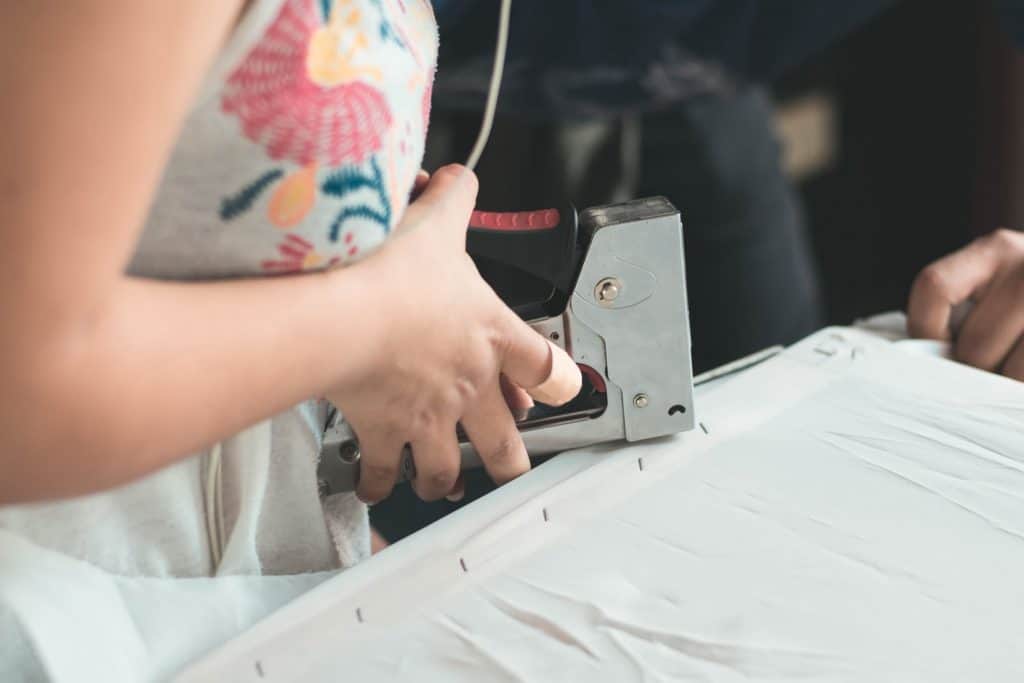 A person using a staple gun 