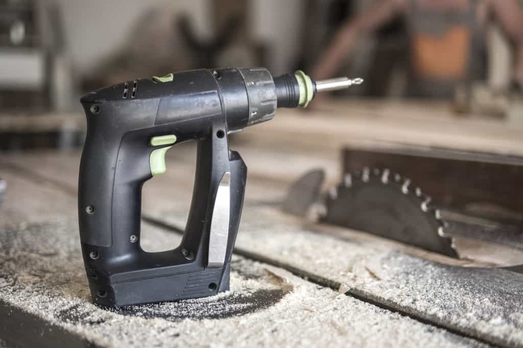 Drill on top of an old table saw that needs a clean up