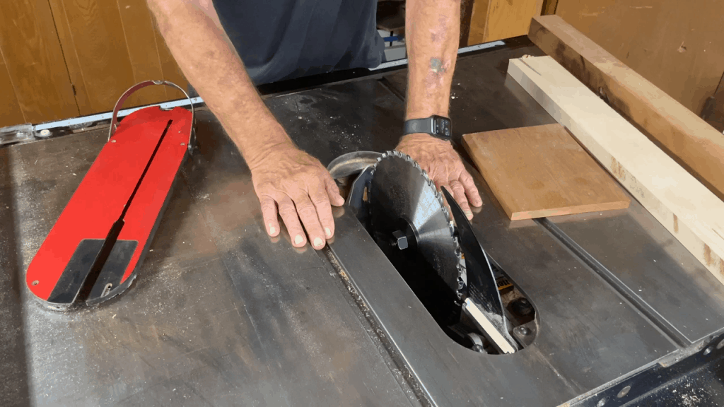 Man showing the table saw blades with arbors
