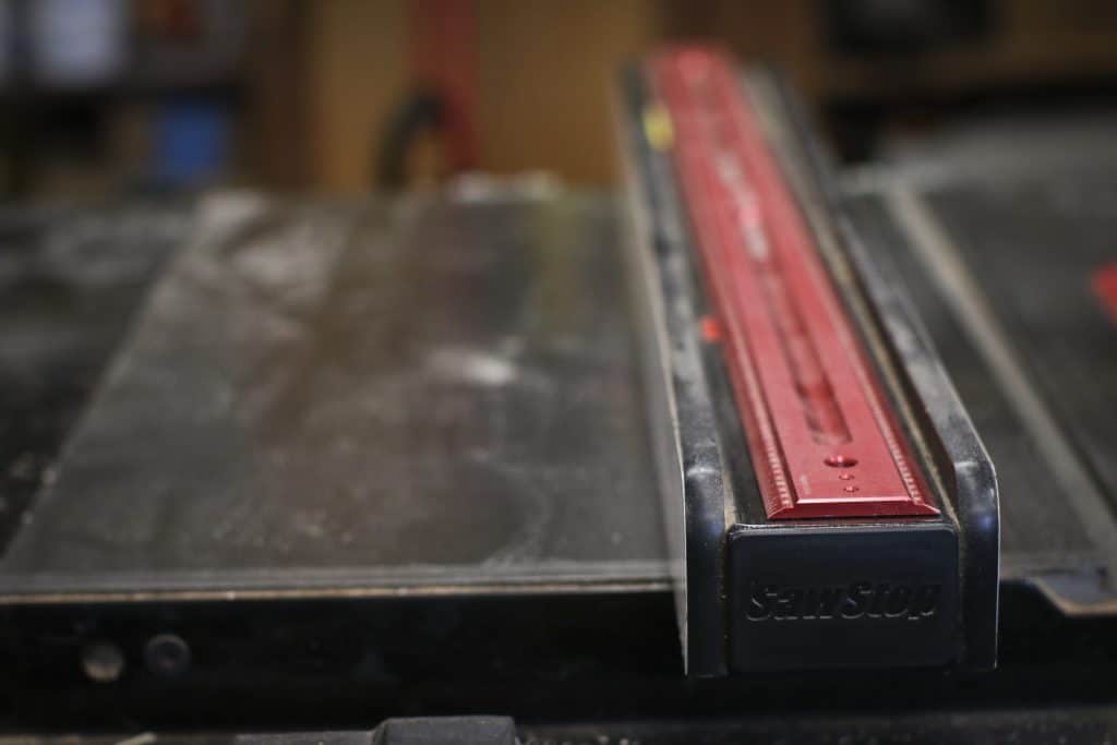 Table saw fence on top of a cast iron stand table saw