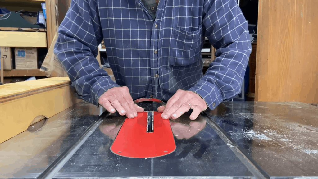 Man trying to remove the zero clearance table saw insert