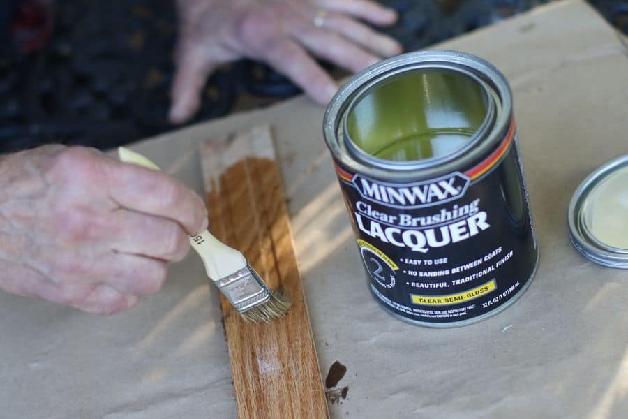 Hand brushing lacquer on a piece of wood