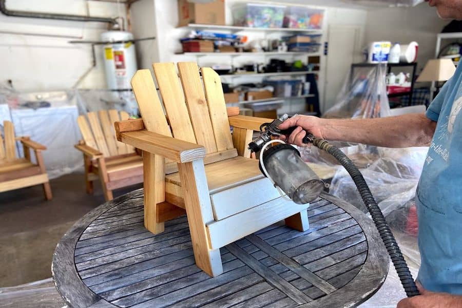 Man holding a stain sprayer