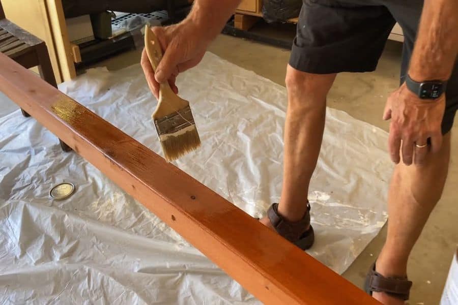 Man applying stain on a piece of wood