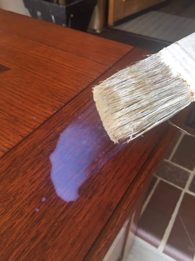 Stain removal solution placed on furnished wood