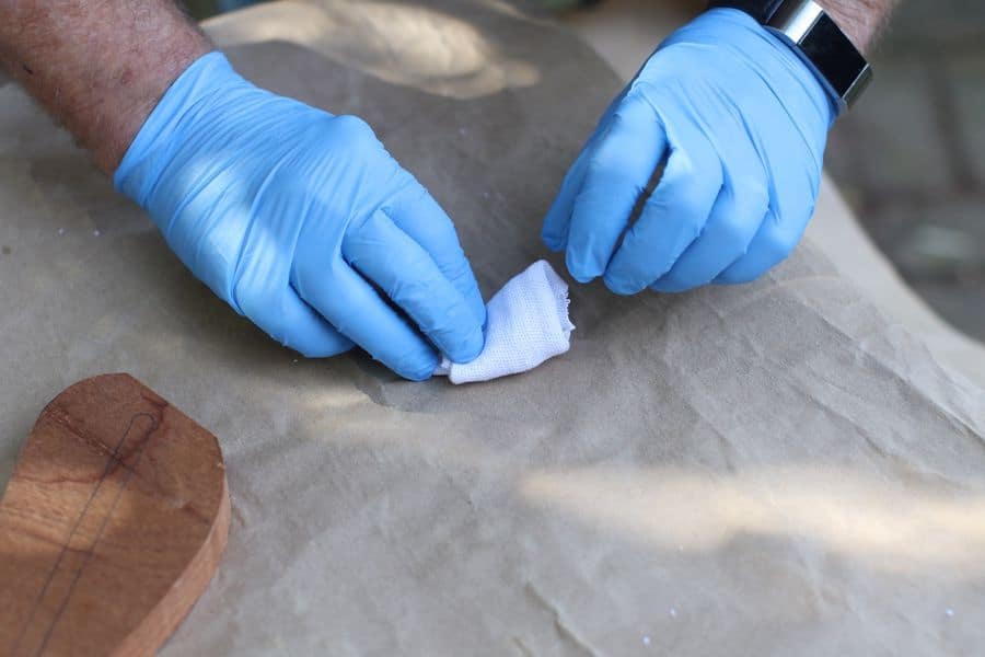 Gloved hands rolling a piece of cloth